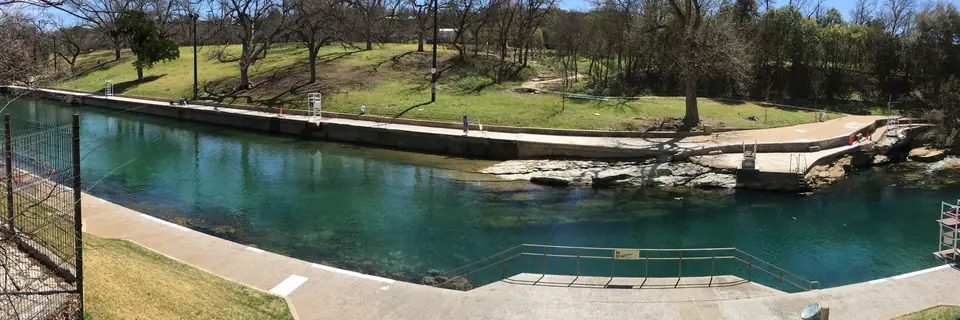 Barton Springs Pool and its grassy banks, photographed in March 2016.